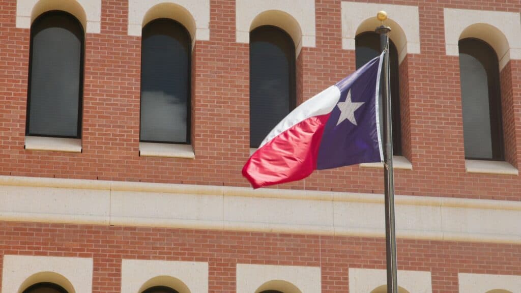Texas State Flag against Brick Building Facade in Laredo, Texas